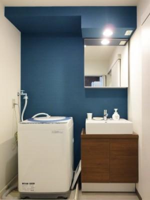 青のクロスが印象的な洗面室に